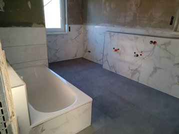 Fliesenarbeiten im Bad eines Neubaus