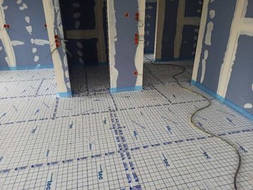 Vorbereitungen des Bodens eines Bungalow 128 für die Fußbodenheizung